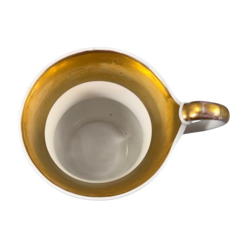 fig 2. A 19th-century KPM Berlin porcelain cabinet cup with a fully gilded interior, high curved loop handle, and hand-painted topographical view of Peacock Island.