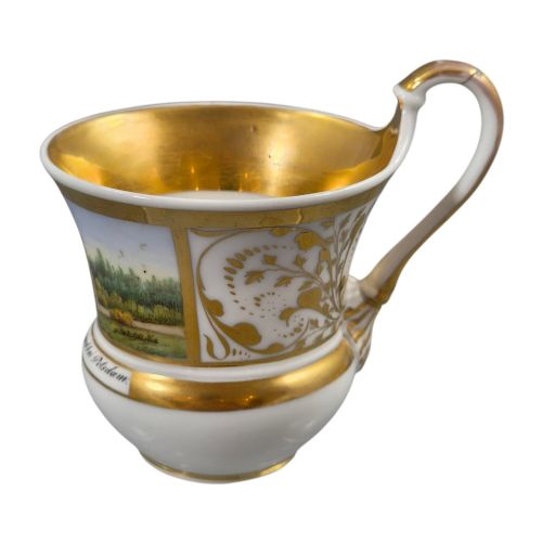 fig 4. A 19th-century KPM Berlin porcelain cabinet cup with a fully gilded interior, high curved loop handle, and hand-painted topographical view of Peacock Island.