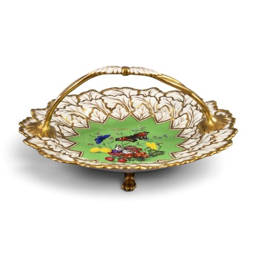 fig 1. A Regency Flight, Barr and Barr Worcester porcelain handle basket featuring a bright green central reserve decorated with hand-painted butterflies and berries, surrounded by a leaf-moulded rim and gilt handle.