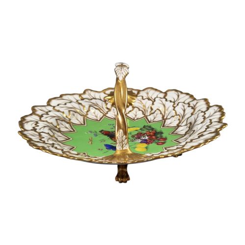 fig 4. A Regency Flight, Barr and Barr Worcester porcelain handle basket featuring a bright green central reserve decorated with hand-painted butterflies and berries, surrounded by a leaf-moulded rim and gilt handle.