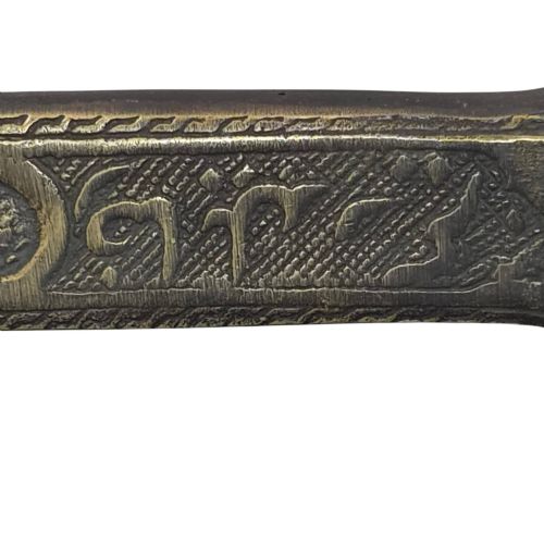 fig 4. An antique cast and engraved brass travelling pen case and integrated inkwell featuring ornate scrollwork patterns and script.