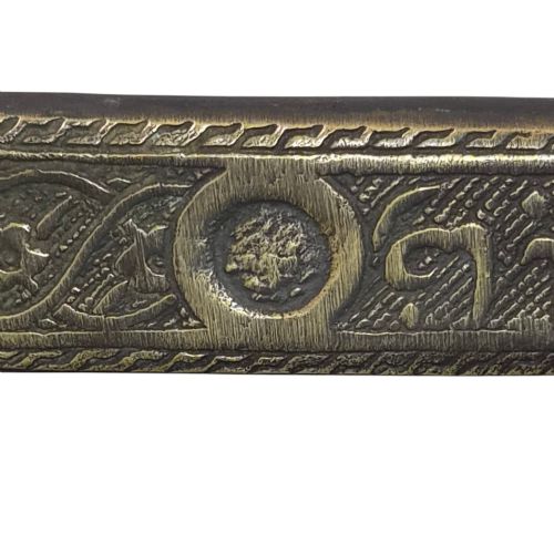 fig 5. An antique cast and engraved brass travelling pen case and integrated inkwell featuring ornate scrollwork patterns and script.