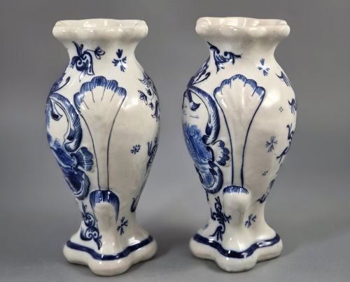fig 1. A pair of baluster-shaped blue and white hand-painted French faience vases featuring equestrian scenes and scrollwork motifs.