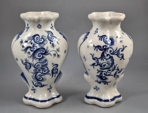 fig 2. A pair of baluster-shaped blue and white hand-painted French faience vases featuring equestrian scenes and scrollwork motifs.