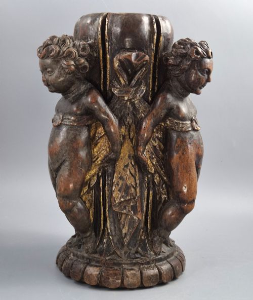 fig 1. A dark carved walnut Italian Baroque torchiere base featuring three sculpted putti figures standing around a central fluted shaft on a gadrooned circular base.