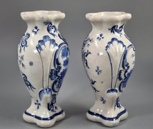fig 3. A pair of French Desvres faience baluster vases featuring hand-painted blue equestrian scenes framed by molded Rococo scrollwork against a white glaze.