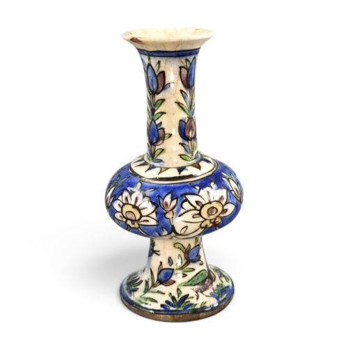 fig 3. A late Qajar Persian polychrome ceramic vase featuring a central bulbous knop, flared rim, crackle glaze finish, and painted blue and green floral motifs.