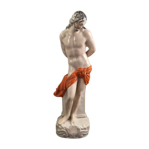 fig 3. A Victorian earthenware figurine depicting Christ standing at a column draped in a terracotta-coloured cloth on a scrollwork base.