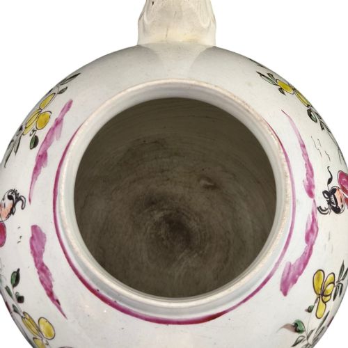fig 7. An 18th-century creamware teapot featuring hand-painted polychrome Chinoiserie figures on a cream glaze background with a curved spout and loop handle.
