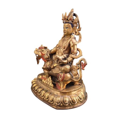 fig 3. A gilt bronze figure of the deity Jambhala crowned and adorned with jewellery, seated upon a snow lion atop an oval lotus pedestal base with red and blue painted accents.