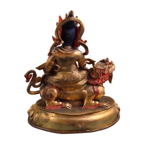 fig 5. A gilt bronze figure of the deity Jambhala crowned and adorned with jewellery, seated upon a snow lion atop an oval lotus pedestal base with red and blue painted accents.