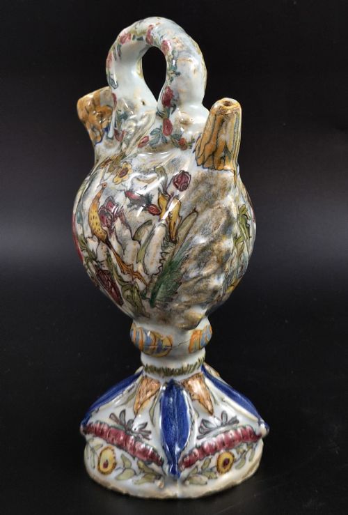 fig 1. An 18th-century Italian majolica pilgrim flask featuring a scallop-shell body, twin spouts, loop handles, a pedestal foot, and hand-painted polychrome flora and fauna.