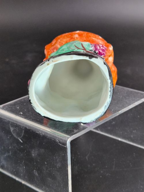 fig 5. A 19th-century Royal Staffordshire porcelain stirrup cup molded in the form of a fox head with painted orange, black, green, and purple enamels.