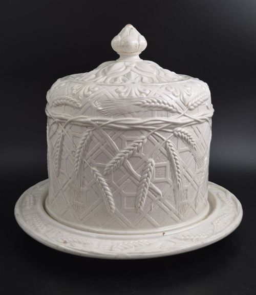 fig 1. An off-white Victorian ironstone cheese dome and matching circular stand with molded relief lattice work and wheat sheaf motifs.