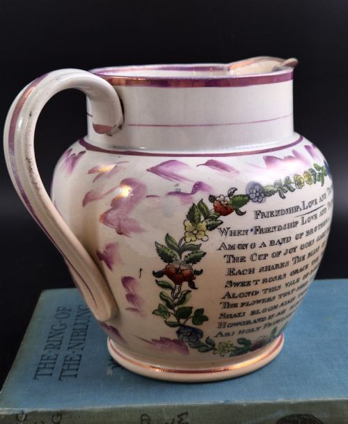 fig 2. An antique cream earthenware jug decorated with pink splash lustre glaze and a central transfer print depicting the Iron Bridge over the Wear.