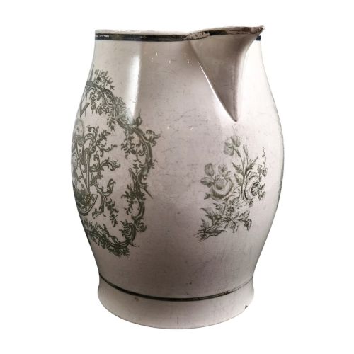 fig 2. A Georgian Staffordshire creamware jug featuring transfer-printed olive-green Masonic iconography framed by a leafy scrollwork wreath.