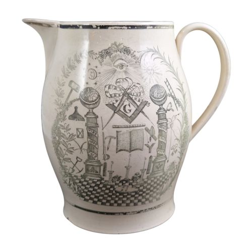 fig 4. A Georgian Staffordshire creamware jug featuring transfer-printed olive-green Masonic iconography framed by a leafy scrollwork wreath.