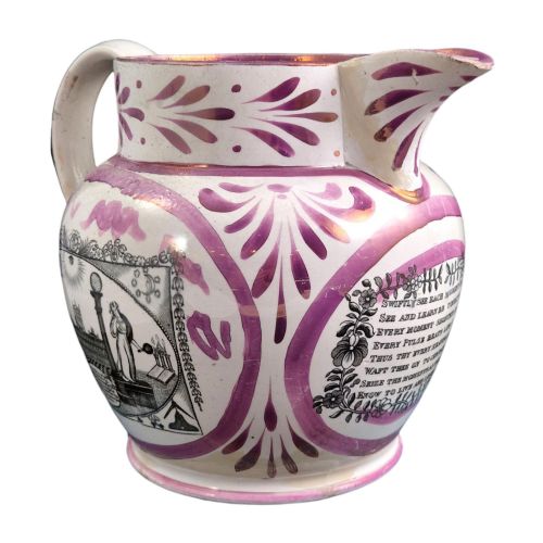 fig 1. An antique white earthenware jug decorated with pink metallic lustre foliage borders and a black transfer-printed Masonic emblem featuring twin columns and symbolic motifs.