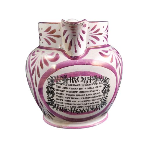 fig 2. An antique white earthenware jug decorated with pink metallic lustre foliage borders and a black transfer-printed Masonic emblem featuring twin columns and symbolic motifs.