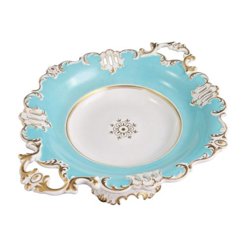 fig 2. A Victorian Coalport bone china tazza featuring a turquoise border, central floral motif, gilded scroll accents, and a footed stem base.
