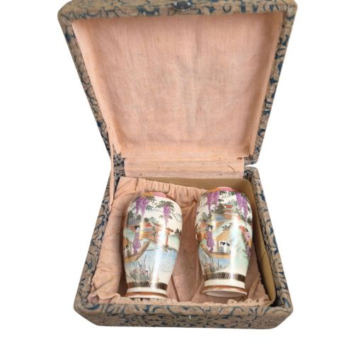 fig 2. A pair of cream ceramic Satsuma vases decorated with hand-painted scenes of purple wisteria, figures in boats, and pagodas with gilded highlights.
