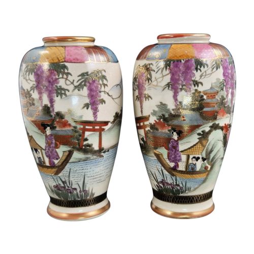fig 3. A pair of cream ceramic Satsuma vases decorated with hand-painted scenes of purple wisteria, figures in boats, and pagodas with gilded highlights.