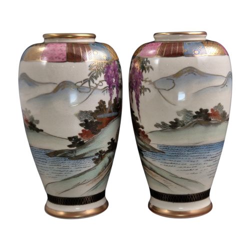 fig 6. A pair of cream ceramic Satsuma vases decorated with hand-painted scenes of purple wisteria, figures in boats, and pagodas with gilded highlights.