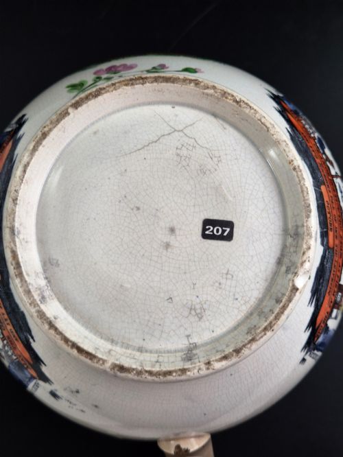 fig 5. A cream earthenware jug featuring hand-painted floral motifs, copper lustre trim, and a printed Orange Order emblematic coat of arms with religious and fraternal symbols.