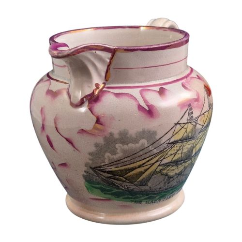 fig 2. An antique cream earthenware jug featuring pink splash lustre decoration and a hand-coloured transfer print of Masonic coats of arms.