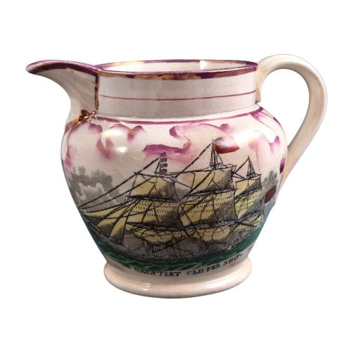 fig 3. An antique cream earthenware jug featuring pink splash lustre decoration and a hand-coloured transfer print of Masonic coats of arms.