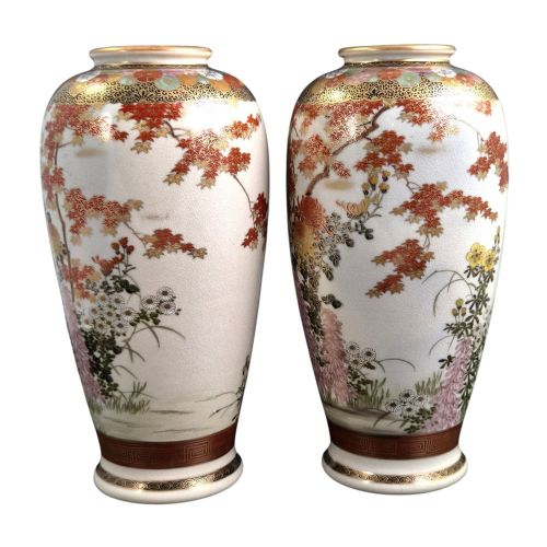 fig 1. A pair of Japanese Satsuma earthenware vases decorated with intricate hand-painted floral motifs, autumn maple leaves, chrysanthemums, and gold accents over a crackle glaze.