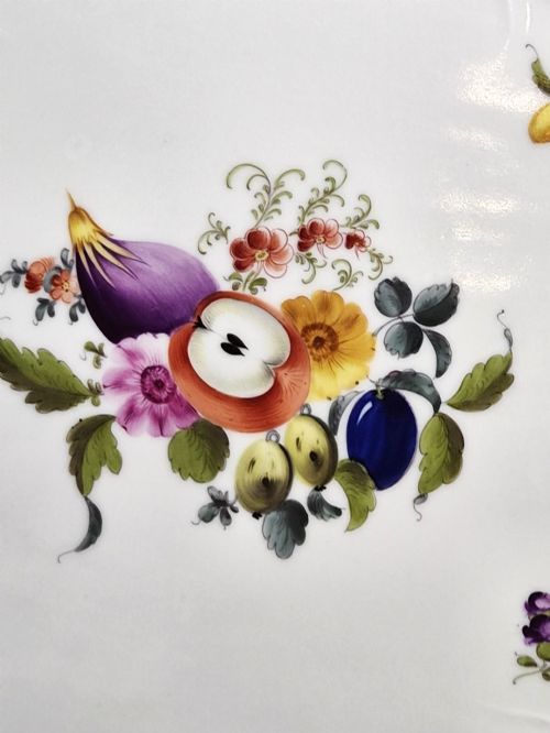 fig 2. An oval white porcelain tray featuring hand-painted fruit and insect motifs, moulded basketweave border, pink painted ribbon handles, and a gilded rim.