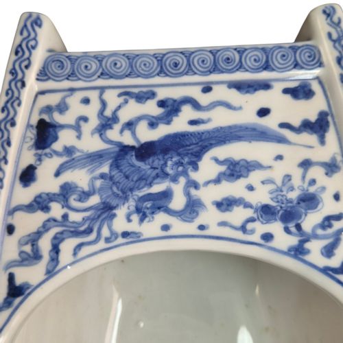 fig 1. A Japanese blue and white porcelain vessel shaped like a boat featuring a carved dragon figurehead at the prow.