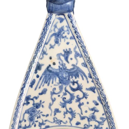 fig 2. A Japanese blue and white porcelain vessel shaped like a boat featuring a carved dragon figurehead at the prow.