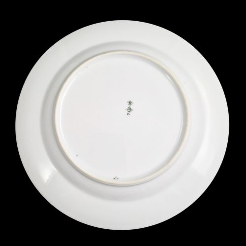 fig 1. A circular white porcelain plate with twin gilded rim borders and a small Russian Imperial double-headed eagle crest near the top edge.