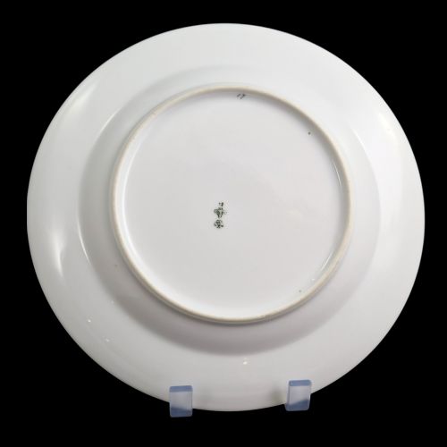 fig 3. A circular white porcelain plate with twin gilded rim borders and a small Russian Imperial double-headed eagle crest near the top edge.