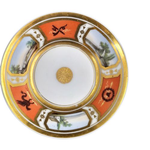 fig 1. A French Old Paris porcelain cup and saucer featuring gilded trim, interior gold wash, and hand-painted panels depicting rural figures.
