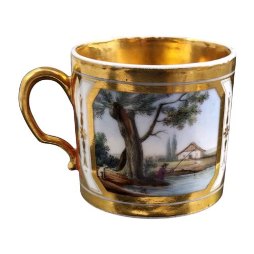 fig 5. A French Old Paris porcelain cup and saucer featuring gilded trim, interior gold wash, and hand-painted panels depicting rural figures.