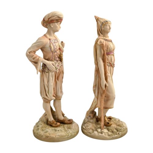 fig 4. A pair of late Victorian Royal Worcester blush ivory porcelain figures depicting an Indian man and woman in detailed traditional attire with gilded accents.