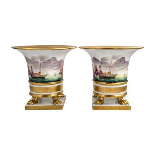 fig 3. A pair of flared white porcelain Empire-style vases decorated with hand-painted sailing ships and supported by gilded paw feet.