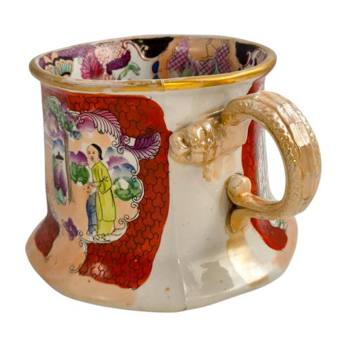 fig 1. An antique Masons ironstone cider mug featuring a red scale background, hand-painted Chinoiserie panels, a flared base, and a sculpted hydra handle.