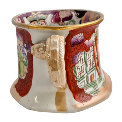 fig 2. An antique Masons ironstone cider mug featuring a red scale background, hand-painted Chinoiserie panels, a flared base, and a sculpted hydra handle.