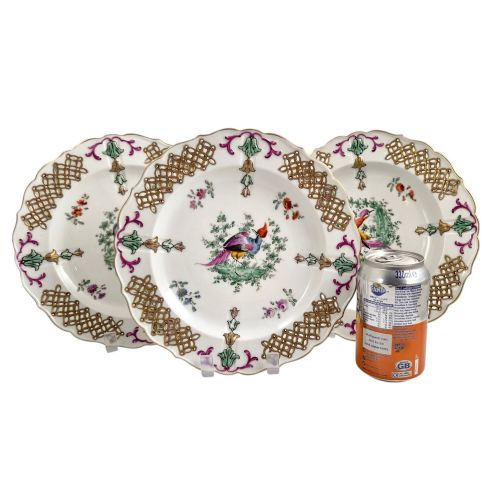 fig 1. Set of three white porcelain cabinet plates featuring pierced lattice rims decorated with gold gilding, pink scrolls, green accents, and hand-painted exotic birds in the centre.