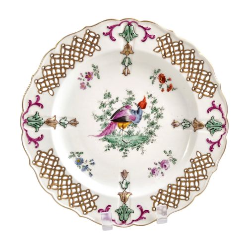 fig 2. Set of three white porcelain cabinet plates featuring pierced lattice rims decorated with gold gilding, pink scrolls, green accents, and hand-painted exotic birds in the centre.