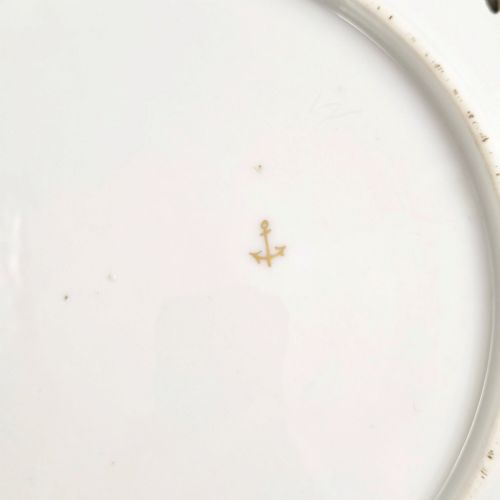 fig 4. Set of three white porcelain cabinet plates featuring pierced lattice rims decorated with gold gilding, pink scrolls, green accents, and hand-painted exotic birds in the centre.