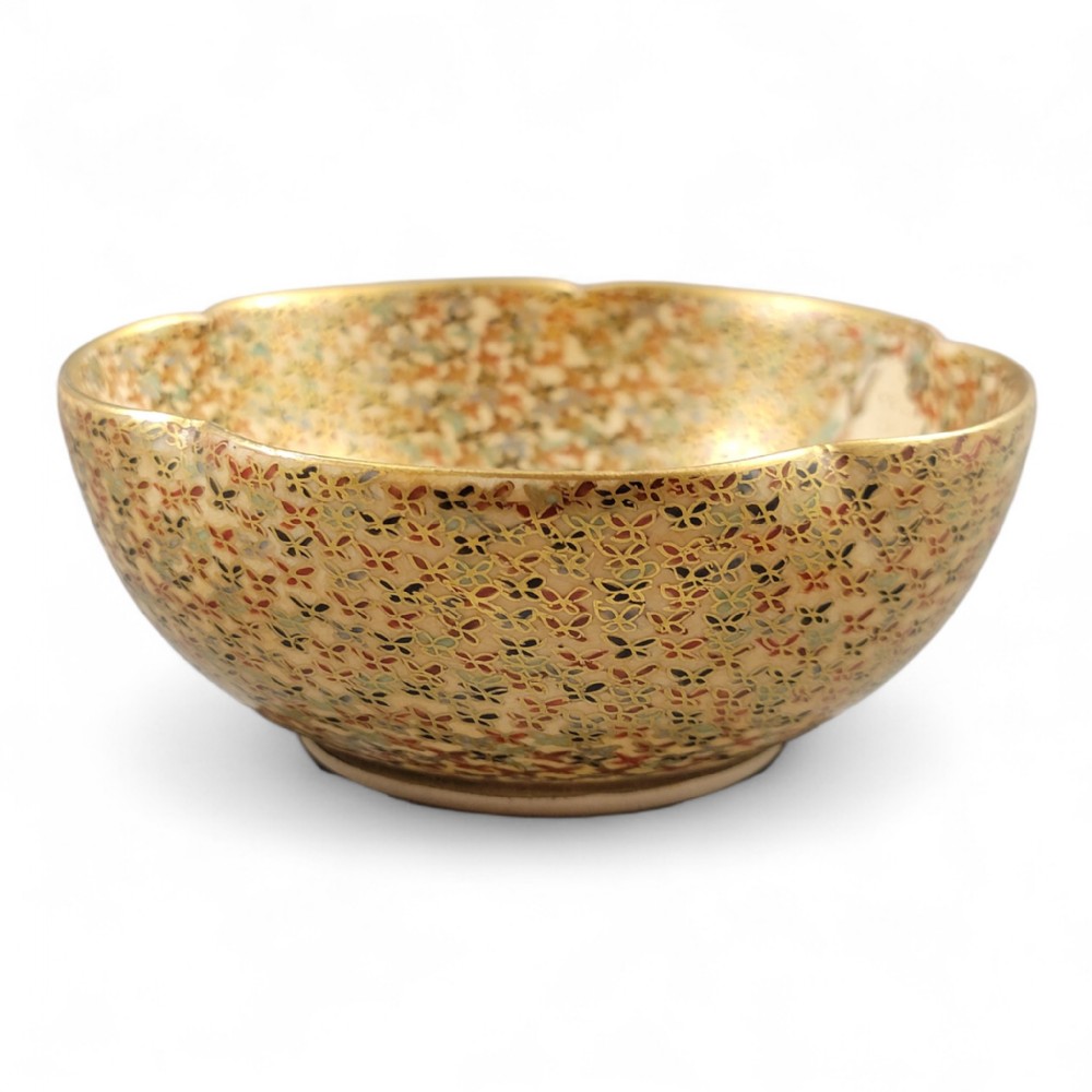 A lobed Japanese Satsuma earthenware bowl with intricate polychrome enamel and gold gilding across the interior and exterior surface.