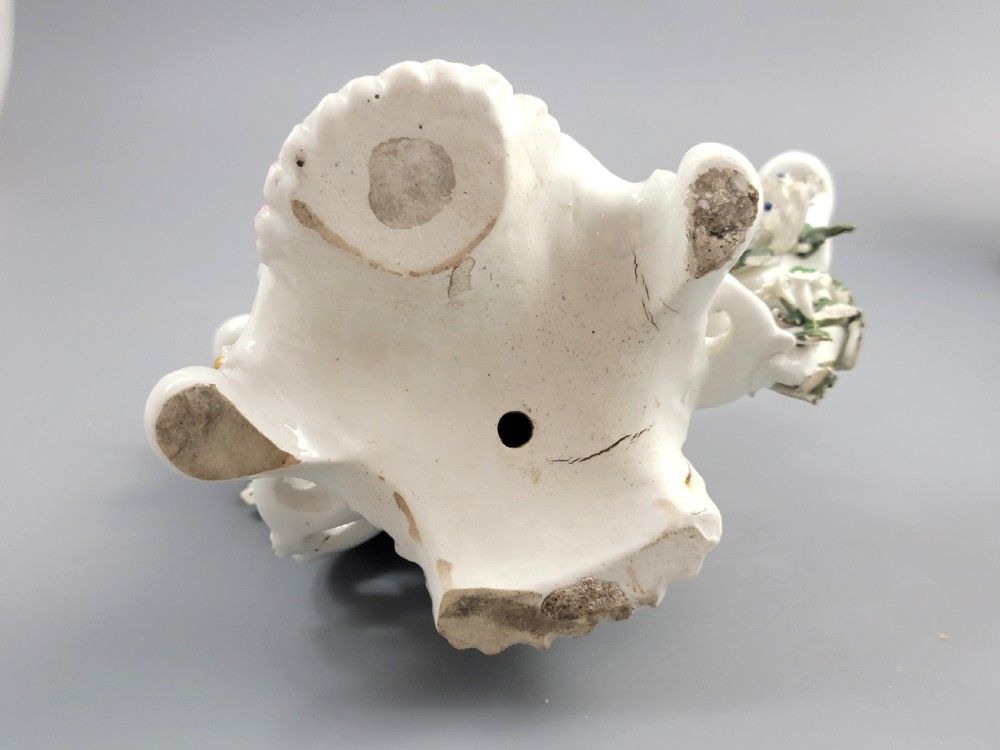 A pair of 18th-century English Derby porcelain candlestick figures depicting musicians surrounded by intricate floral bocage on Rococo scroll bases. View VI