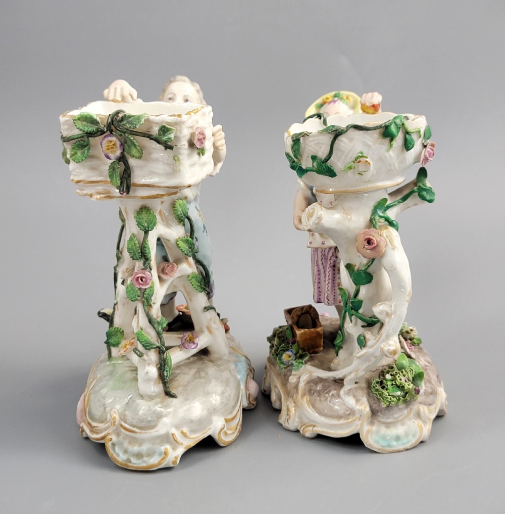 A pair of late nineteenth-century Volkstedt porcelain sweetmeat figures featuring a male and female figure picking fruit beside basket dishes on rococo bases. View II