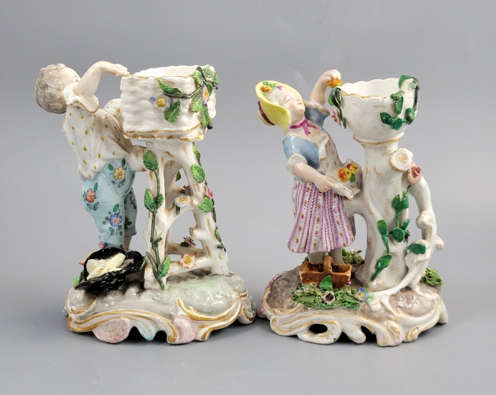 A pair of late nineteenth-century Volkstedt porcelain sweetmeat figures featuring a male and female figure picking fruit beside basket dishes on rococo bases. View III