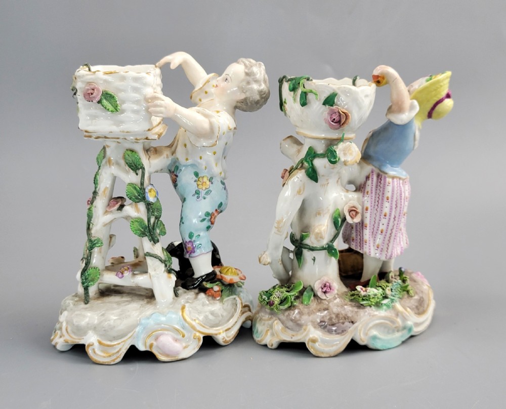 A pair of late nineteenth-century Volkstedt porcelain sweetmeat figures featuring a male and female figure picking fruit beside basket dishes on rococo bases. View IV